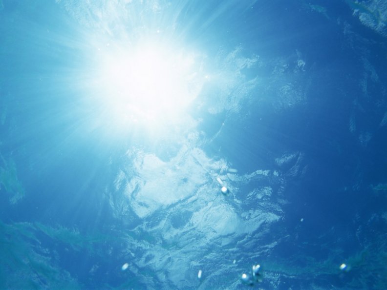 Underwater surface waves and sunlight