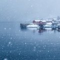 snow storm over norwegian seaside village