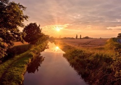 beautiful sunset over countryside canal