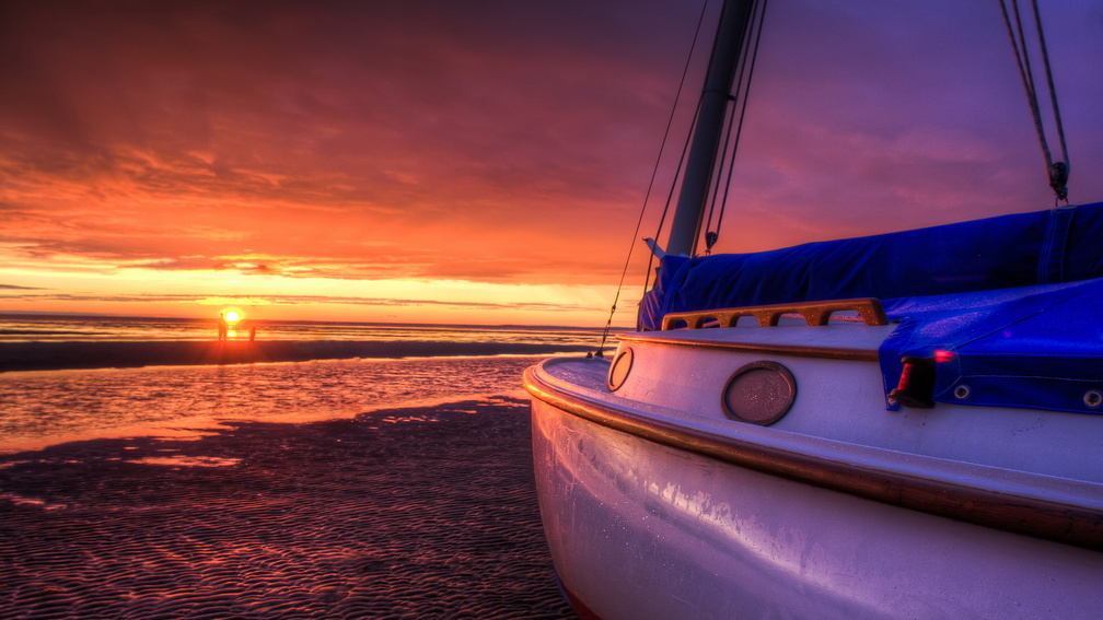 gorgeous sunset on a beached sailboat hdr