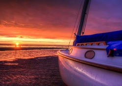 gorgeous sunset on a beached sailboat hdr