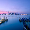 boat piers across the lagoon from venice at sunset