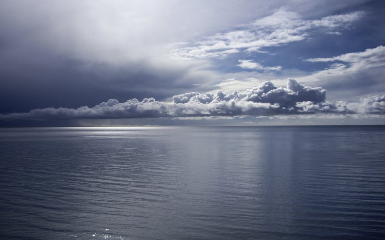 Calm sea with clouds on the horizon