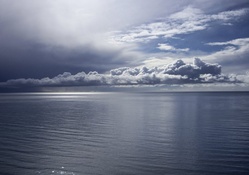Calm sea with clouds on the horizon