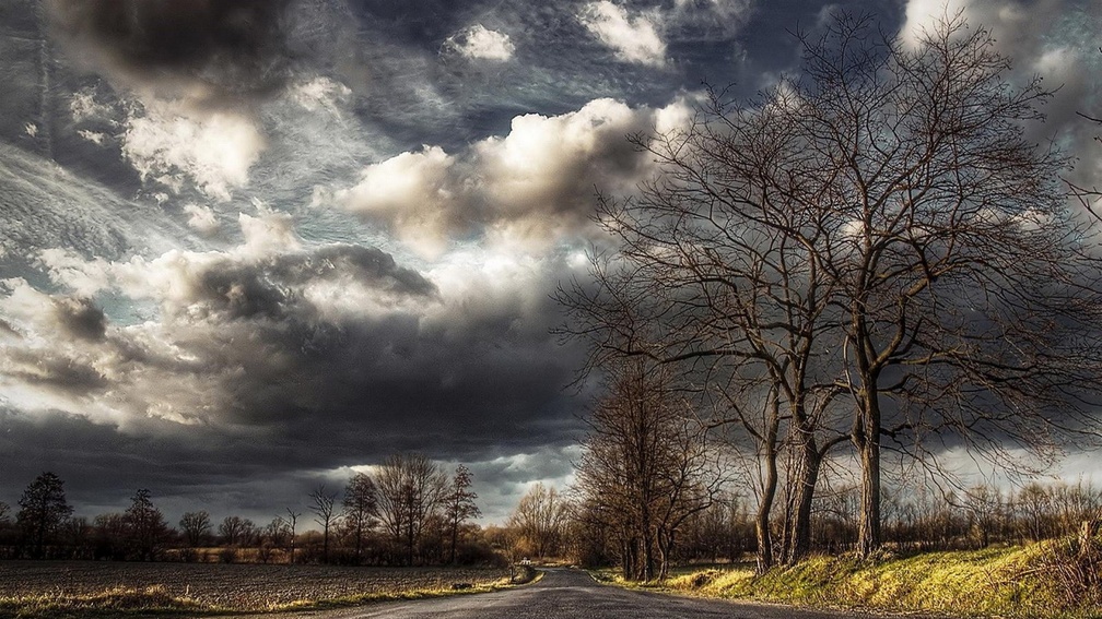 superb clouds over countryside road hdr