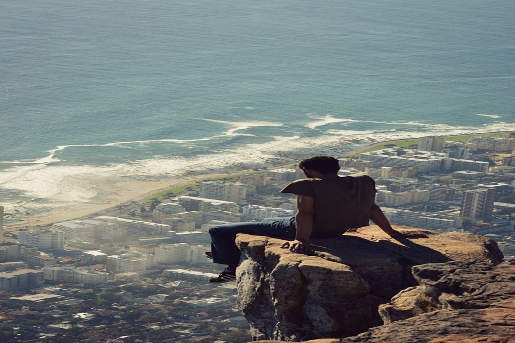 Awesome Picture of a Man Sitting on a Cliff Ledge in Cape Town