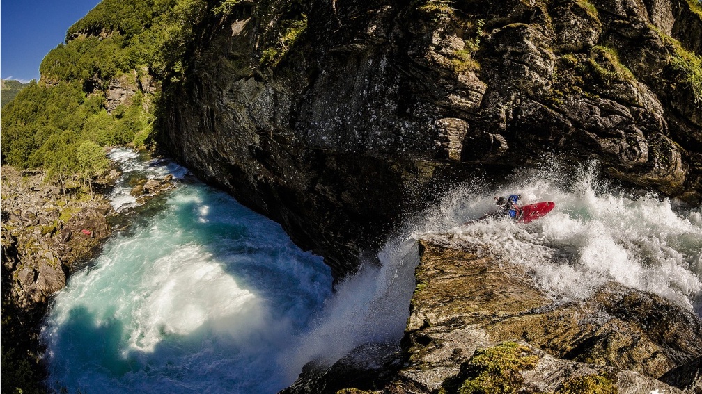 kayaking over extreme river rapids