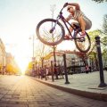 trick biking in the street at sunrise