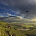 parachute skydiving into a beautiful valley