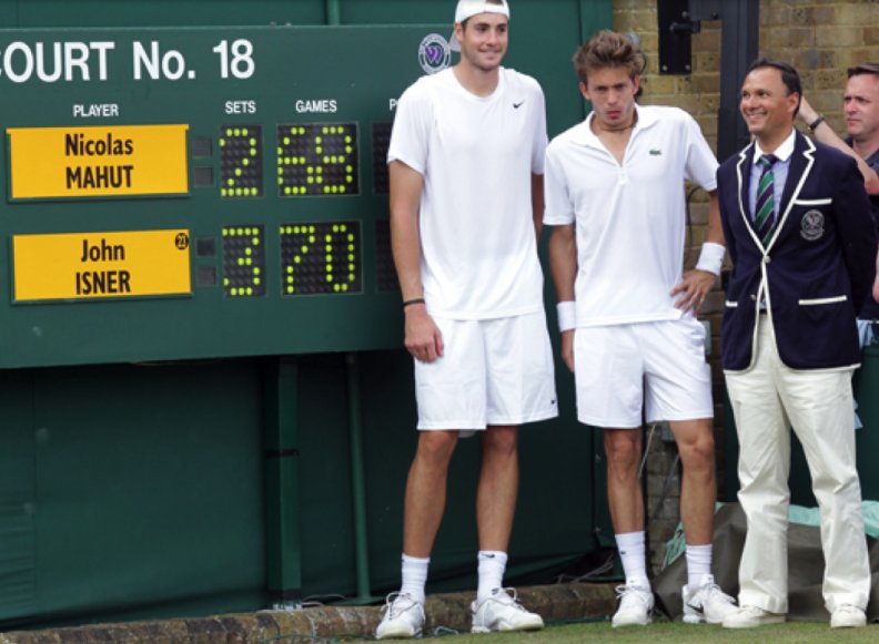John Isner, Nicolas Mahut &amp; Umpire standing next to the historic scoreboard after the longest match in Open history.