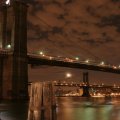 brooklyn bridge under a cloudy night