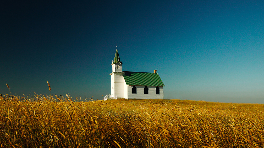 lovely green roofed church in wheat fields