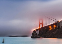 the golden gate bridge under fog