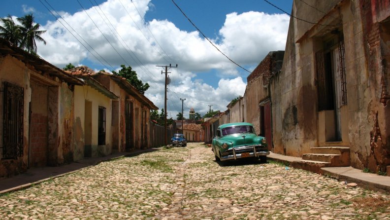 old cars on a street in a cuban barrio