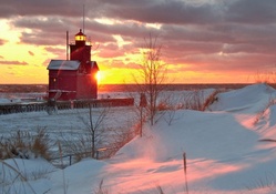 beautiful red lighthouse on a winter morning