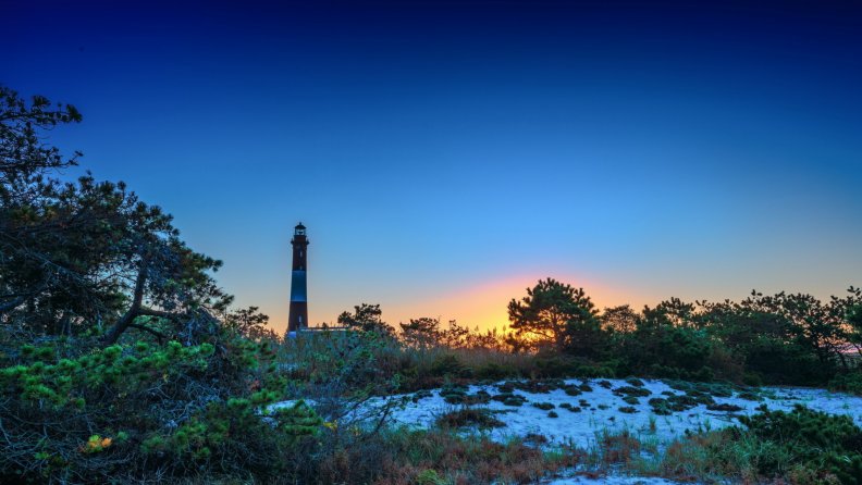 tall_lighthouse_among_beach_shrubs_at_twilight_hdr.jpg