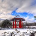 beautiful red oriental arbor in a winterscape