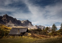 mountains above a cabin in a meadow