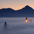 church tower peeking through morning fog