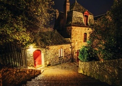 steps outside a stone house at night
