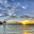 gorgeous stilted bungalows in a maldives sunset hdr