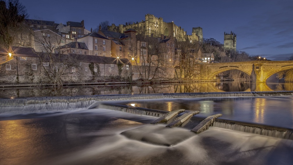 castle above a flowing river at night hdr
