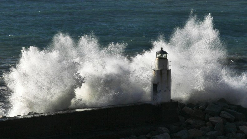 stormy sea wave smashing into lighthouse