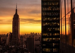 reflection of the empire state building at sunset