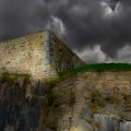 dark clouds over stone castle walls