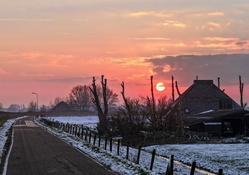 road through farmlands at sunrise