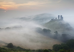 ruins on a hill in morning fog