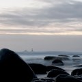 lighthouse off a rocky seashore