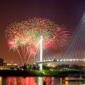 fireworks over modern pedestrian bridge