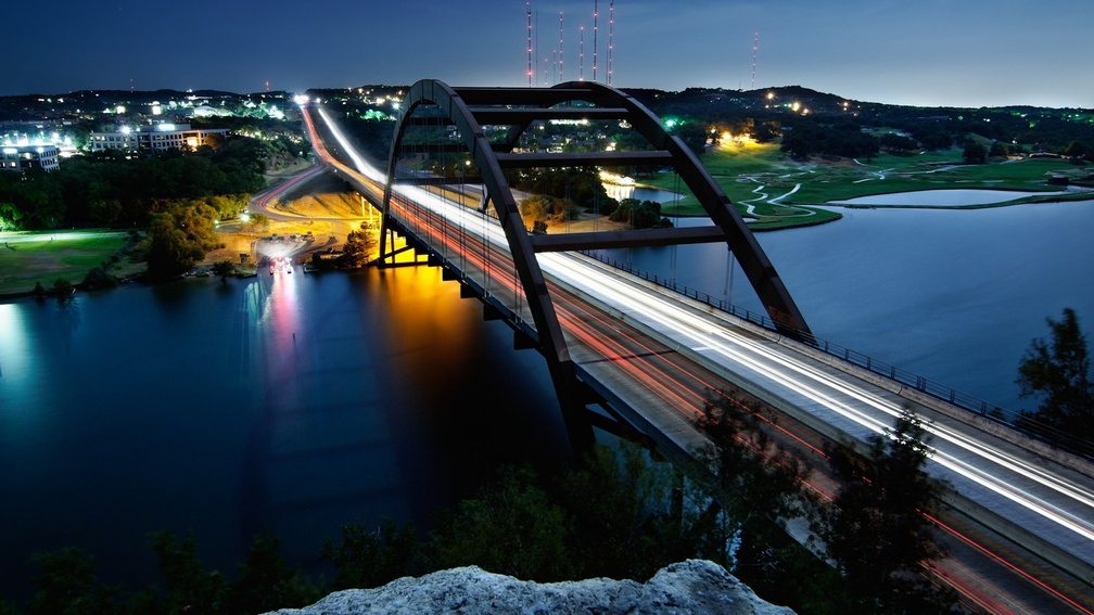 arched steel bridge at night in long exposure