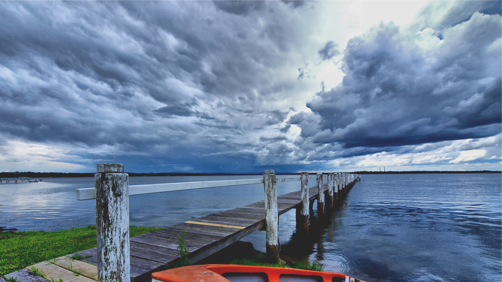 stormy clouds over a bay pier