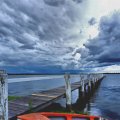 stormy clouds over a bay pier