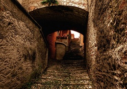 stone steps up a dark alleyway