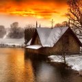 stone river home on a winter sunset