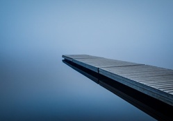 dock on a calm foggy lake