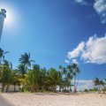 tall lighthouse on a tropical beach