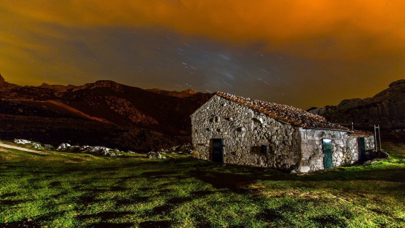 stone hut under starry sky