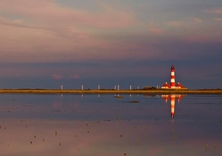 beautiful red and white lighthouse reflected