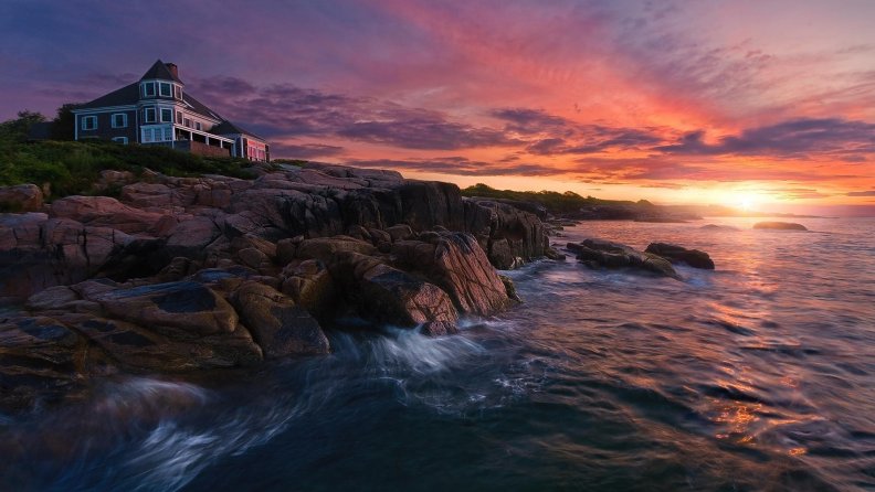 lovely_home_on_a_rocky_seashore_at_sunset.jpg