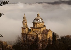 wonderful hillside italian church in fog