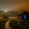 a bright lighthouse on a foggy night