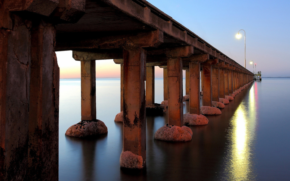 cement pillared pier in a calm sea