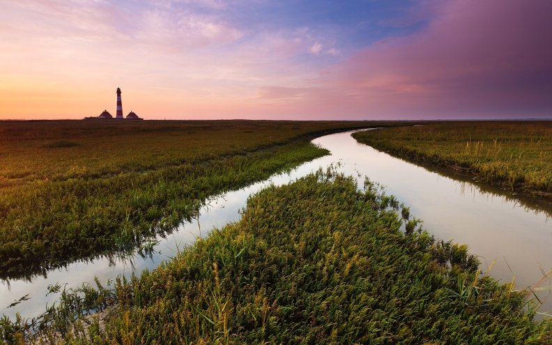 irrigation canal and lighthouse at a distance