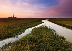 irrigation canal and lighthouse at a distance