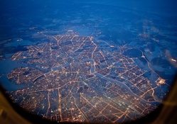 city grid in lights from an airplane window