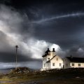 lighthouse under stormy skies